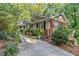 Charming home with brick and tan siding, complemented by well-maintained landscaping and a paved driveway at 5775 Lakeshore Dr, Buford, GA 30518
