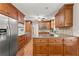 Spacious kitchen features ample wood cabinetry, granite countertops, stainless steel appliances, and hardwood floors at 5775 Lakeshore Dr, Buford, GA 30518