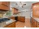 Well-appointed kitchen featuring granite countertops, wood cabinets, stainless steel appliances, and hardwood floors at 5775 Lakeshore Dr, Buford, GA 30518