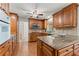 Eat-in kitchen with wood cabinets, granite countertops, stainless appliances, and hardwood floors for a warm and inviting space at 5775 Lakeshore Dr, Buford, GA 30518