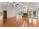Bright living room features hardwood floors, a stone fireplace, vaulted ceilings, and natural light from multiple windows at 5775 Lakeshore Dr, Buford, GA 30518