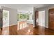 Light-filled main bedroom with hardwood floors and a view to a wooded backyard at 5775 Lakeshore Dr, Buford, GA 30518