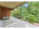 Spacious covered patio offering a relaxing outdoor space with views of the lush backyard at 5775 Lakeshore Dr, Buford, GA 30518