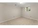 An empty room featuring neutral walls, light-colored flooring, and a window letting in natural light at 5775 Lakeshore Dr, Buford, GA 30518
