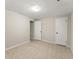 An empty room with neutral walls and light-colored flooring features two entryways and a window at 5775 Lakeshore Dr, Buford, GA 30518
