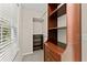 Bright walk-in closet features custom wood shelving and ample storage space and a window at 5775 Lakeshore Dr, Buford, GA 30518