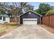 Detached black garage with white door and a concrete driveway at 980 Moreland Se Ave, Atlanta, GA 30316
