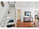 Living area showcasing a modern staircase, hardwood floors, and a large TV at 980 Moreland Se Ave, Atlanta, GA 30316