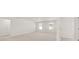 Spacious bedroom with neutral carpeting and two windows at 608 Kimberwick Dr, Locust Grove, GA 30248