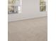 Well-lit bedroom featuring neutral carpeting and large windows at 608 Kimberwick Dr, Locust Grove, GA 30248