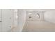 Bright and airy bedroom with carpet flooring and access to another room at 608 Kimberwick Dr, Locust Grove, GA 30248