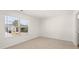Well-lit bedroom featuring a large window and carpet at 608 Kimberwick Dr, Locust Grove, GA 30248
