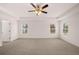 Main bedroom with ceiling fan and multiple windows at 608 Kimberwick Dr, Locust Grove, GA 30248