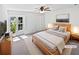 Bright staged bedroom showcasing a large window, and a ceiling fan at 7131 Forest Ln, Union City, GA 30291