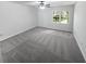 Cozy bedroom with a ceiling fan, plush gray carpet, neutral walls, and a sunlit window at 7131 Forest Ln, Union City, GA 30291