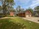 Charming brick home featuring a two-car garage and a well-manicured lawn at 7131 Forest Ln, Union City, GA 30291