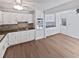 Bright kitchen featuring white cabinetry, stainless steel appliances, and hardwood flooring at 7131 Forest Ln, Union City, GA 30291
