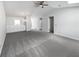 Bright living room featuring plush gray carpeting, modern lighting fixture and convenient built-in storage cabinetry at 7131 Forest Ln, Union City, GA 30291