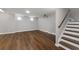 Finished basement with sleek wood floors, recessed lighting, and a modern projector setup at 905 Freedom Ln, Roswell, GA 30075