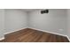 Basement with sleek wood floors, grey walls, and a mounted TV bracket ready for your entertainment setup at 905 Freedom Ln, Roswell, GA 30075