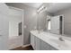 Bathroom featuring a double sink vanity and a view of the shower at 905 Freedom Ln, Roswell, GA 30075