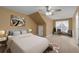 Bright bedroom features carpeted floors, ceiling fan, and sitting area near a window at 905 Freedom Ln, Roswell, GA 30075