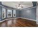 A very spacious room that includes hardwood flooring, modern trim, and large window features at 905 Freedom Ln, Roswell, GA 30075