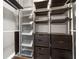 Organized walk-in closet with shelves and drawers to maximize storage space at 905 Freedom Ln, Roswell, GA 30075