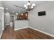 Bright dining area adjacent to the kitchen with a modern chandelier and bar seating at 905 Freedom Ln, Roswell, GA 30075