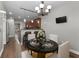 Stylish dining area with a modern chandelier adjacent to the kitchen with seating for four at 905 Freedom Ln, Roswell, GA 30075
