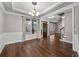 Spacious dining room with hardwood floors, chandelier, and natural light at 905 Freedom Ln, Roswell, GA 30075