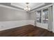 Formal dining room with hardwood floors, wainscoting, and a large window at 905 Freedom Ln, Roswell, GA 30075