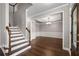 Elegant entryway with hardwood floors, staircase, and dining room at 905 Freedom Ln, Roswell, GA 30075