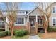 Charming townhome with a welcoming front porch and well-maintained landscaping at 905 Freedom Ln, Roswell, GA 30075