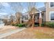 Street view of townhomes, each featuring a private front porch and landscaped entrance at 905 Freedom Ln, Roswell, GA 30075