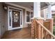 Inviting front porch features brick accents and a decorated front door at 905 Freedom Ln, Roswell, GA 30075