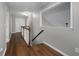 Hallway featuring hardwood flooring, wood railing, and natural light at 905 Freedom Ln, Roswell, GA 30075