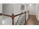 Staircase leading to hallway featuring hardwood flooring at 905 Freedom Ln, Roswell, GA 30075