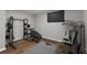Basement home gym featuring weights, workout machines, and wood floors at 905 Freedom Ln, Roswell, GA 30075