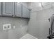Convenient laundry room with cabinets and tiled flooring at 905 Freedom Ln, Roswell, GA 30075