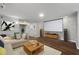 Staged basement living room with projector screen, modern furniture, and wood floors at 905 Freedom Ln, Roswell, GA 30075