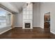 Open living room with fireplace, hardwood floors, and ample natural light at 905 Freedom Ln, Roswell, GA 30075