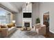 Bright living room with a fireplace, large window and hardwood floors at 905 Freedom Ln, Roswell, GA 30075