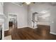 Open-concept floor plan with hardwood floors, fireplace, and staircase to the next level at 905 Freedom Ln, Roswell, GA 30075