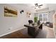 Home office featuring sleek wood floors, tray ceiling, and bright window views at 905 Freedom Ln, Roswell, GA 30075