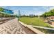 Scenic view of the City Green, featuring a paved walkway, manicured lawn, stage area, and ample seating at 5635 Lake Forrest Dr, Atlanta, GA 30342