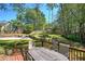 Backyard with a patio, fire pit, and lush landscaping, creating a perfect outdoor entertaining space at 2921 Wickford Nw Dr, Kennesaw, GA 30152