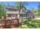 Spacious backyard with wooden deck, patio furniture, and lush green lawn for outdoor enjoyment at 2921 Wickford Nw Dr, Kennesaw, GA 30152