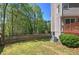 Fenced backyard featuring a lawn, trees, and a wooden fence, providing privacy and space for outdoor enjoyment at 2921 Wickford Nw Dr, Kennesaw, GA 30152