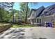 Spacious backyard featuring a deck, lush lawn, basketball hoop, and mature trees, perfect for outdoor living and recreation at 2921 Wickford Nw Dr, Kennesaw, GA 30152